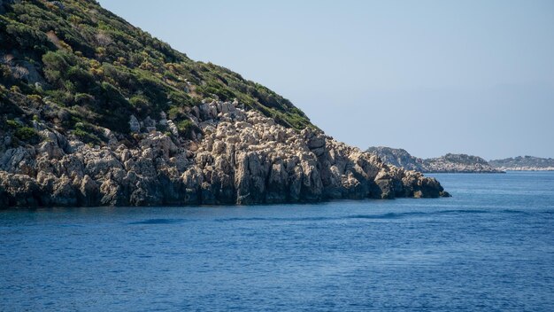 Mountain of rocks in the foreground over the sea