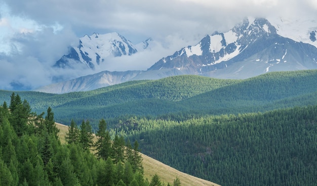 Mountain scenery snowcapped peaks cloudy weather summer