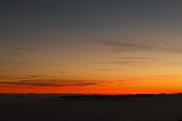 Mountain silhoutte over clouds