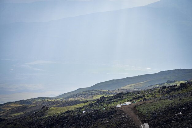 Photo mountain tent campsite set on the side of the mountain hit by soft noon light mount ararat turkey