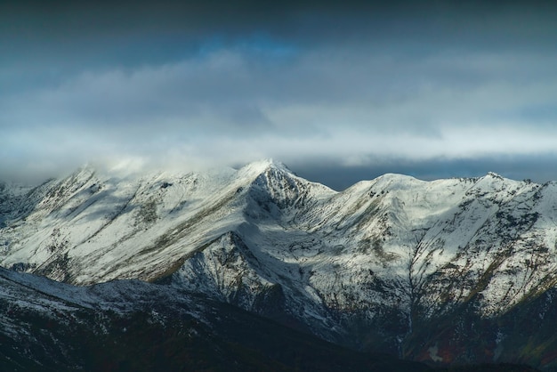 Mountain valley with fog and clouds at morning