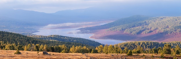 Mountain valley with lake autumn view panorama