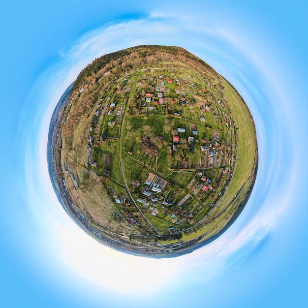 Mountain village among green fields aerial view