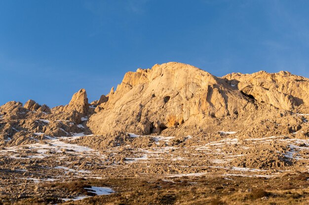 Photo a mountain with a blue sky and snow on the ground