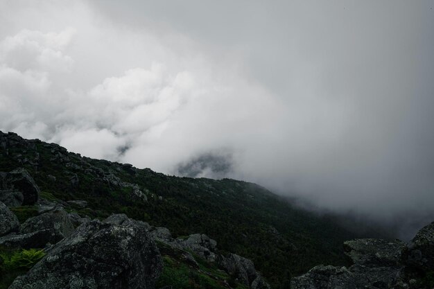 a mountain with a bunch of rocks and a mountain in the background