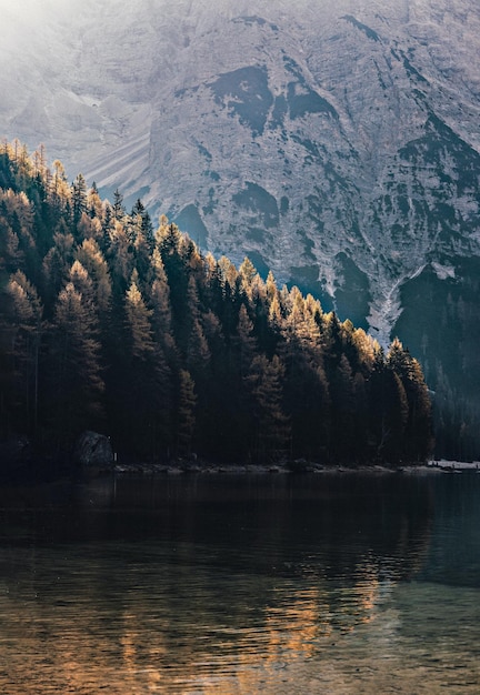 A mountain with a lake and a boat in the foreground