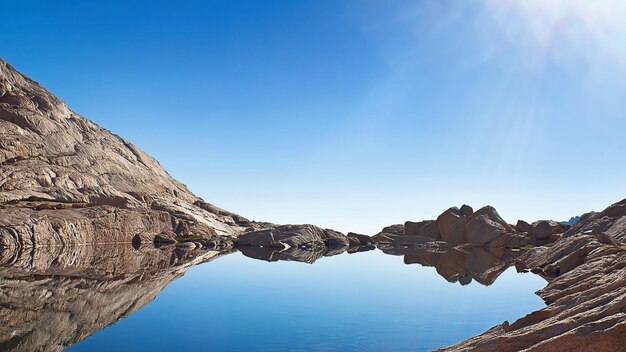 a mountain with a reflection of the sun in the water