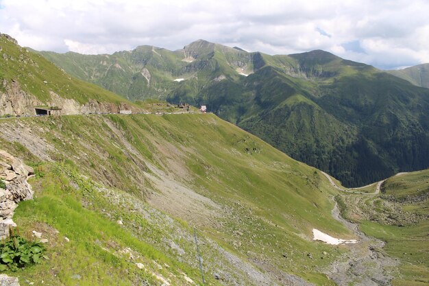 A mountain with a road and a valley