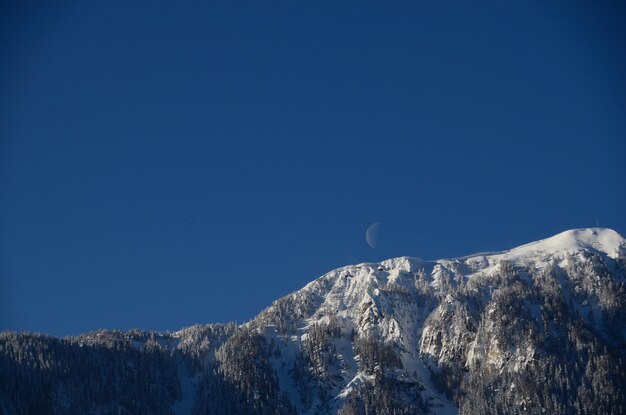 하늘에 눈과 달이 있는 산