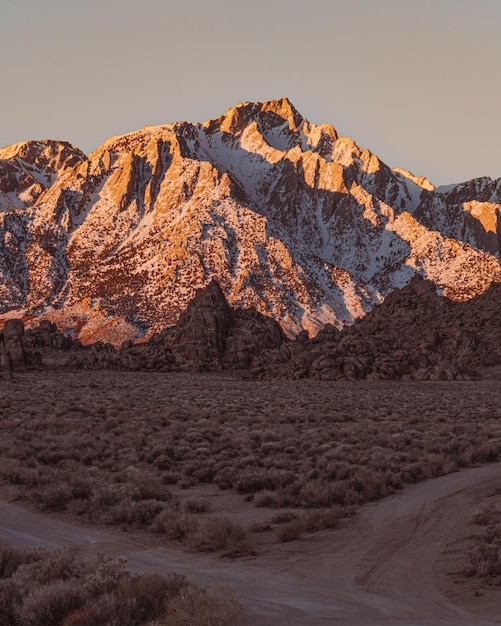 A mountain with the sun setting behind it