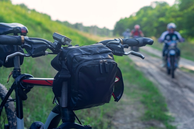 Mountainbike met een tas op het stuur op de achtergrond van motorrijders.