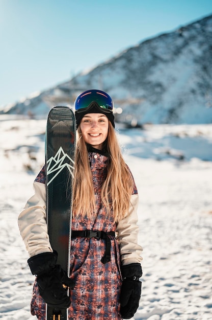 Mountaineer backcountry ski walking ski woman alpinist in the mountains Ski touring in alpine landscape with snowy trees Adventure winter sport Freeride skiing