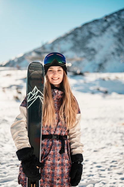 Mountaineer backcountry ski walking ski woman alpinist in the\
mountains ski touring in alpine landscape with snowy trees\
adventure winter sport freeride skiing