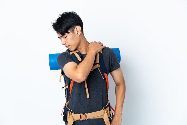 Mountaineer man posing isolated against the white wall