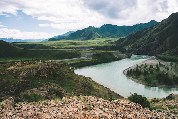 Mountainous river in highlands at overcast weather