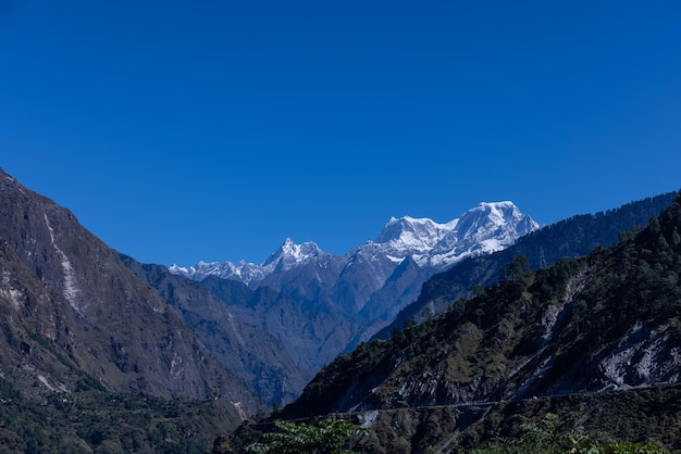 The mountains are covered in snow and the sky is blue.