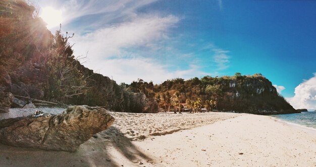 Mountains at beach against sky