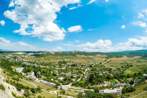 Mountains on blue sky background with clouds on Sunny day.