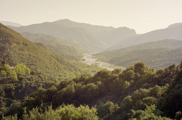 The mountains and the river Kalarrytikos on a sunny summer day