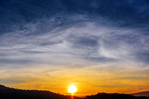 Mountains valley during sunrise with cloudscape background 