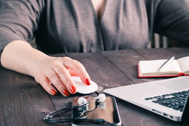 Mouse click, woman hand with mouse and laptop