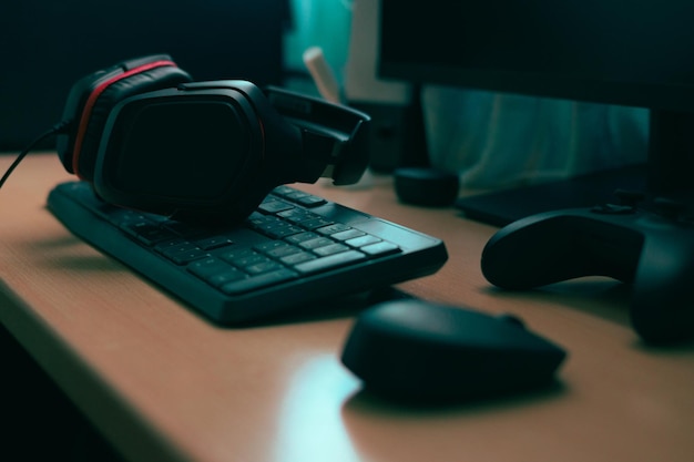 Mouse keyboard headphones video game controller Complements of a computer on a desk