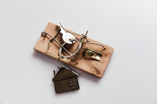 Mousetrap with house key Top view Fraud or crime in real estate