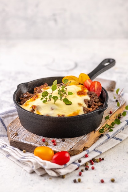 Moussaka. Traditional Greek dish. Chopped beef or lamb meat baked with eggplants, tomatoes and cheese.