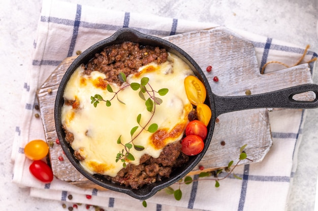 Moussaka. Traditional Greek dish. Chopped beef or lamb meat baked with eggplants, tomatoes and cheese.