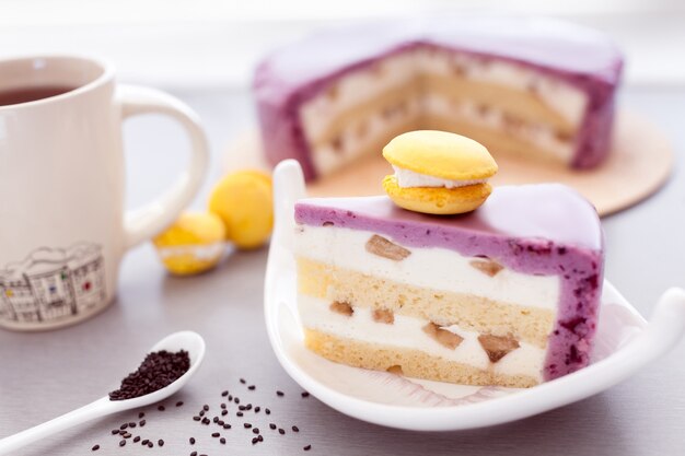 Mousse cake of currant and biscuit with yellow macaroon and coffee