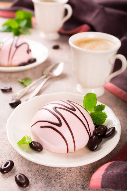 Mousse cakes covered with pink glaze 