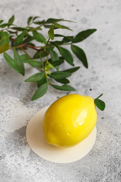 Mousse dessert in the shape of a pear fruit, orange fruit, apricot, lemon and cherry.