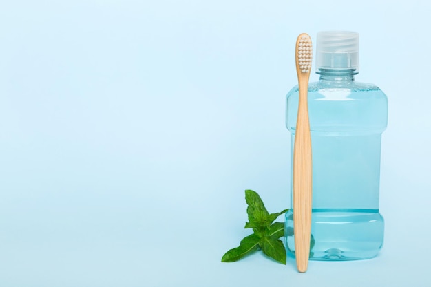 Mouthwash and fresh mint on colored background top view with copy space for text