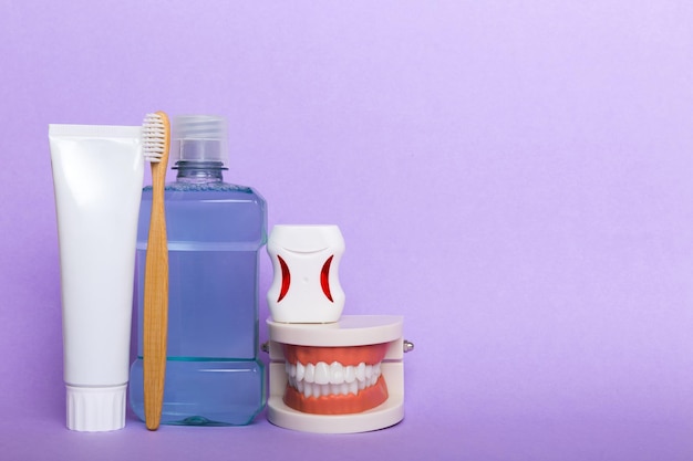 Mouthwash and other oral hygiene products on colored table top\
view with copy space flat lay dental hygiene oral care kit dentist\
concept