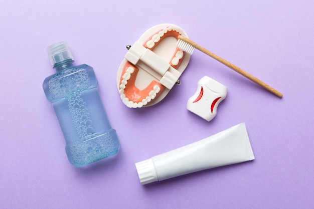 Mouthwash and other oral hygiene products on colored table top\
view with copy space flat lay dental hygiene oral care kit dentist\
concept