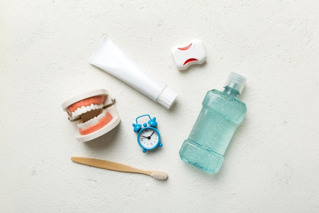 Mouthwash and other oral hygiene products on colored table top view with copy space Flat lay Dental hygiene Oral care kit Dentist concept