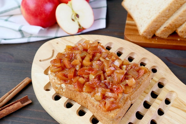 Mouthwatering homemade apple compote toast on wooden breadboard