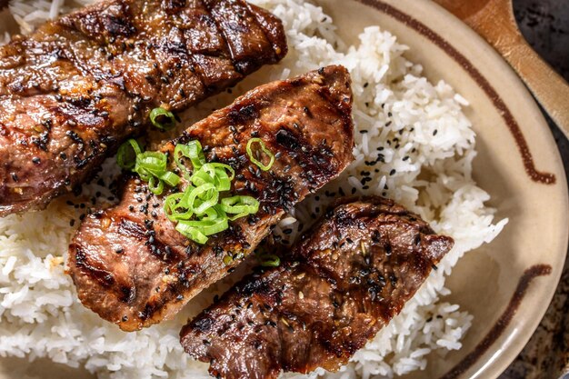 Mouthwatering Kalbi Delight Top CloseUp of Delicious Grilled Kalbi on Steamed White Rice in 4k