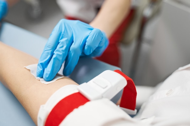 do not move. competent researcher using sterile equipment while going to sample blood for analysis
