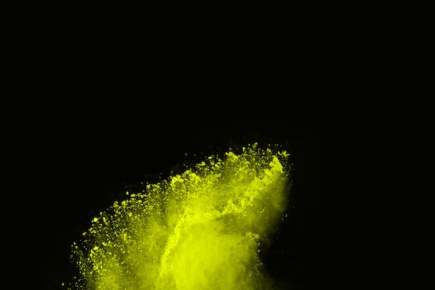 The movement of abstract dust explosion frozen green on black background. 