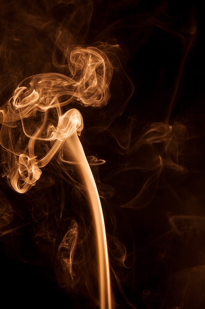 Movement gold smoke on black background.