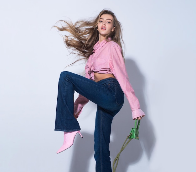 Movement model young glamour woman wearing stylish fashion dress fashion woman in pink shirt and jeans