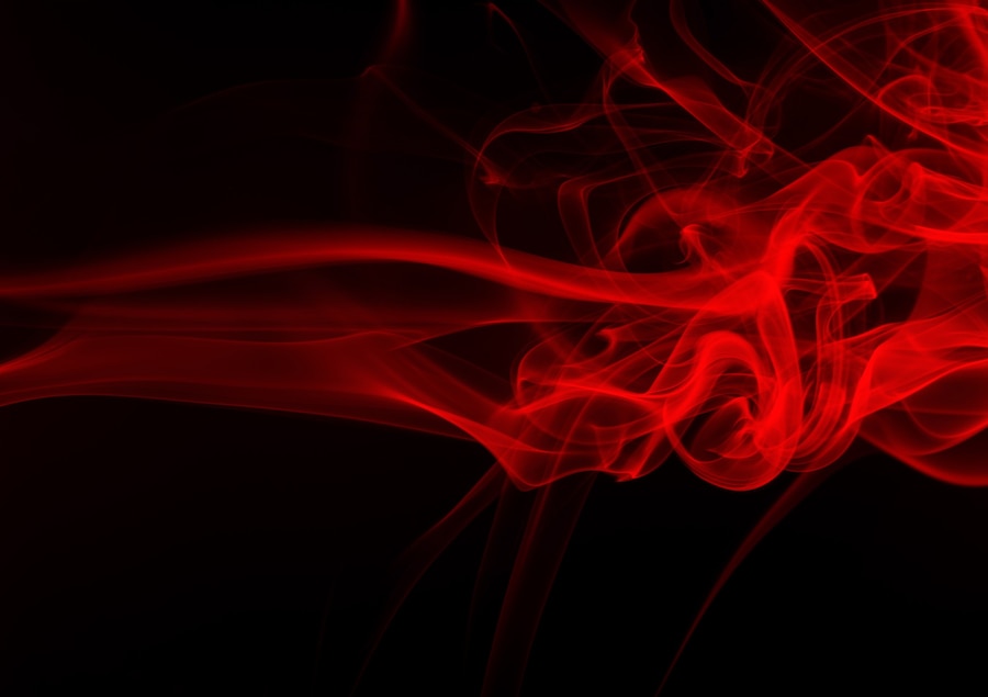 Premium Photo | Movement of red smoke abstract on black for background