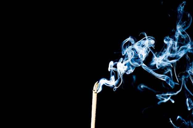 Movement of smoke from  joss stick on black background