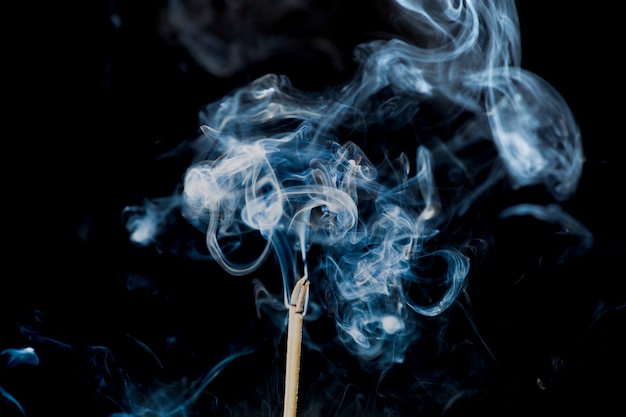 Movement of smoke from  joss stick on black background