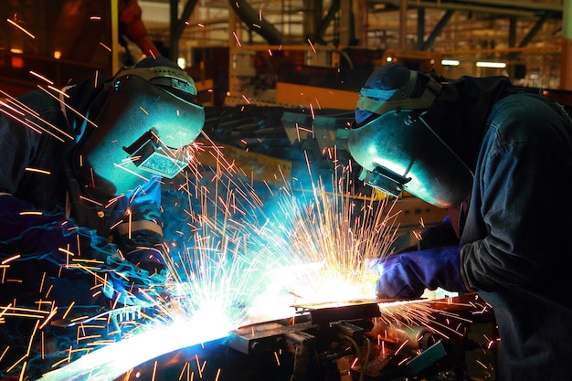 The movement of workers with protective mask welding metal.