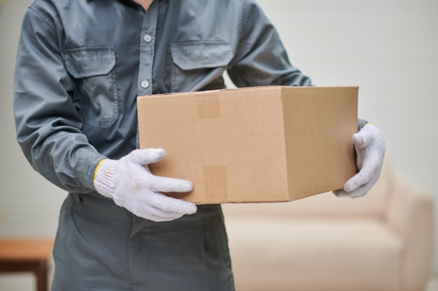 Mover Holding Cardboard Box