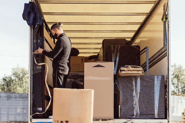 Photo mover strapping a bed to the moving truck