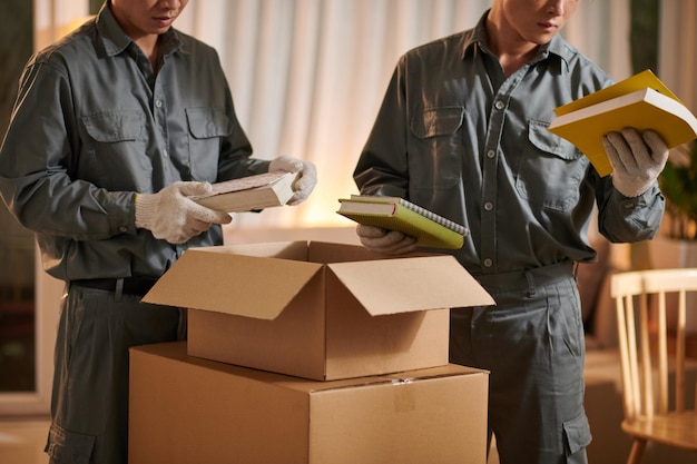 Movers Putting books in Boxes