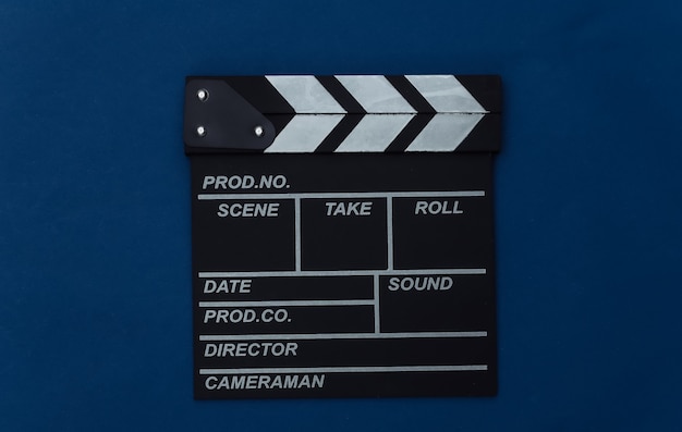 Photo movie clapper board on classic blue background. filmmaking, movie production, entertainment industry. color 2020. top view